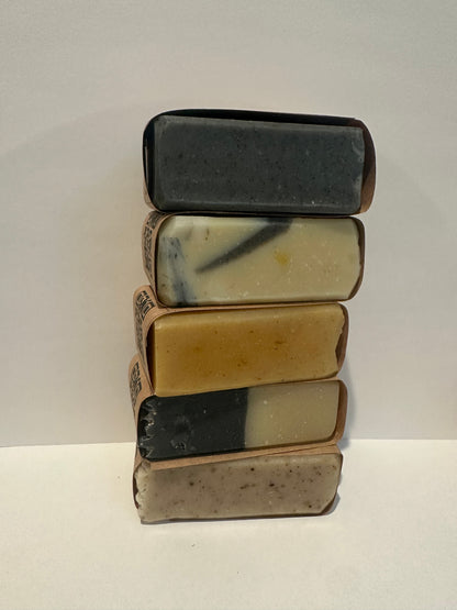 Five Hyssop Bloom mini bar soaps of varying colors arranged in a row on a light gray background